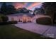 Inviting home exterior featuring a well-manicured lawn, elegant arched windows, and a spacious driveway at 2587 Penngate Dr, Sherrills Ford, NC 28673