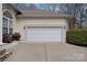 Spacious two-car garage with concrete driveway and lush landscaping at 2587 Penngate Dr, Sherrills Ford, NC 28673