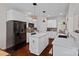 Well-lit kitchen featuring a central island, stainless steel appliances, and hardwood floors at 2587 Penngate Dr, Sherrills Ford, NC 28673