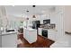 Bright kitchen features white cabinetry, an island, hardwood floors, and stainless steel appliances at 2587 Penngate Dr, Sherrills Ford, NC 28673