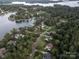 An aerial view of waterfront homes in a neighborhood surrounded by a tree lined lake at 2587 Penngate Dr, Sherrills Ford, NC 28673