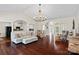Bright living room featuring hardwood floors, a chandelier, and views into the kitchen and entry at 2587 Penngate Dr, Sherrills Ford, NC 28673