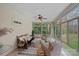 Bright sunroom filled with windows, neutral paint, ceiling fan, and comfortable furnishings for relaxing at 2587 Penngate Dr, Sherrills Ford, NC 28673