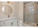 Bathroom features modern vanity, round mirror, and glass enclosed shower at 2924 Sharon View Rd # C, Charlotte, NC 28210