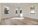 Sunlit bedroom boasts hardwood floors, crisp white trim, and multiple windows offering neighborhood views at 2924 Sharon View Rd # C, Charlotte, NC 28210