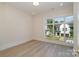 Bedroom features wood floors, neutral walls, and a window with view of exterior at 2924 Sharon View Rd # C, Charlotte, NC 28210