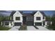 A modern townhouse with a painted white brick facade, large black framed windows, and well manicured front yard at 2924 Sharon View Rd # C, Charlotte, NC 28210