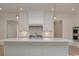 A kitchen with white cabinets, a white countertop island, stainless steel appliances, and pendant lighting at 2924 Sharon View Rd # C, Charlotte, NC 28210