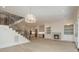 Spacious open-concept area with hardwood floors, featuring a staircase, living room, and modern kitchen at 2924 Sharon View Rd # C, Charlotte, NC 28210