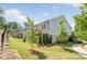 Grassy backyard showcasing a covered patio area and young trees at 3111 Everly Enclave Way, Charlotte, NC 28210