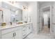 Bathroom with double sink vanity, white cabinets, and marble tile flooring at 3111 Everly Enclave Way, Charlotte, NC 28210
