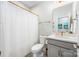 Well-lit bathroom featuring a marble tiled shower and white countertop vanity sink at 3111 Everly Enclave Way, Charlotte, NC 28210