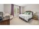 Inviting bedroom featuring neutral walls, comfortable bedding, and a window with natural light at 3111 Everly Enclave Way, Charlotte, NC 28210