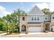 Inviting two-story townhome with brick and siding exterior, attached garage, and a cozy front porch at 3111 Everly Enclave Way, Charlotte, NC 28210