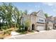 Picturesque two-story townhome featuring brick and siding, an attached garage, and a neatly landscaped yard at 3111 Everly Enclave Way, Charlotte, NC 28210