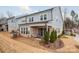 Rear exterior view of the home with a covered patio, sliding door, and a small backyard at 3111 Everly Enclave Way, Charlotte, NC 28210