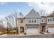 Charming townhome featuring a two-car garage, brick accents, and a welcoming front porch at 3111 Everly Enclave Way, Charlotte, NC 28210