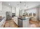 Modern kitchen with stainless steel appliances, a large island, and ample cabinet space at 3111 Everly Enclave Way, Charlotte, NC 28210