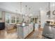 Stylish kitchen with a farmhouse sink, bar seating, and an adjacent dining area at 3111 Everly Enclave Way, Charlotte, NC 28210