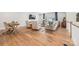 Open-concept living room with hardwood floors and a sitting area with three chairs and sofa at 3111 Everly Enclave Way, Charlotte, NC 28210