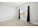 Neutral bedroom featuring a window with a view of the fenced backyard at 4006 Stockbrook Dr, Charlotte, NC 28215