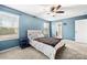 Blue main bedroom with ceiling fan, and natural light from two large windows at 4006 Stockbrook Dr, Charlotte, NC 28215