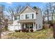 Two story home featuring light siding, blue shutters, a two-car garage and well-maintained landscaping at 4006 Stockbrook Dr, Charlotte, NC 28215
