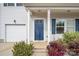 Inviting front porch featuring a blue door with white columns and well-manicured landscaping at 4006 Stockbrook Dr, Charlotte, NC 28215