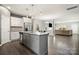 Modern kitchen boasts granite countertops, stainless steel appliances, gray island, and open floorplan at 4006 Stockbrook Dr, Charlotte, NC 28215