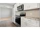 Close-up of kitchen features stainless steel appliances, white cabinets and granite countertops at 4006 Stockbrook Dr, Charlotte, NC 28215