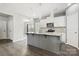Modern kitchen featuring a gray center island, stainless steel appliances and hardwood floors at 4006 Stockbrook Dr, Charlotte, NC 28215