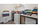 Functional laundry room with modern appliances and ample counter space for folding and organizing clothes at 4006 Stockbrook Dr, Charlotte, NC 28215