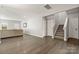 Spacious living room with hardwood floors leading to stairs and neutral décor at 4006 Stockbrook Dr, Charlotte, NC 28215