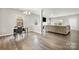 Open-concept living room with dining area, hardwood floors, neutral walls, and an open floor plan at 4006 Stockbrook Dr, Charlotte, NC 28215