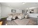 Spacious living room with modern gray walls, hardwood floors, and plush sectional sofa at 4006 Stockbrook Dr, Charlotte, NC 28215