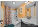 Inviting bathroom includes a shower with floral curtain, modern fixtures, and a sleek black vanity at 405 E 3Rd St, Kannapolis, NC 28083