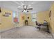 Bright bedroom featuring fresh yellow paint, dual windows, and ample space for a functional office setup at 405 E 3Rd St, Kannapolis, NC 28083