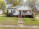 Charming home featuring a covered front porch and a well-maintained lawn at 405 E 3Rd St, Kannapolis, NC 28083