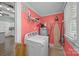 Functional laundry area boasts modern washer, dryer, and ample shelving for easy organization and storage solutions at 405 E 3Rd St, Kannapolis, NC 28083