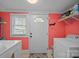 Efficient laundry room with modern appliances, providing convenience and functionality for daily chores at 405 E 3Rd St, Kannapolis, NC 28083