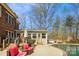 Beautiful backyard with pool, mature trees, patio with lounge chairs, and fenced in yard at 420 Woodlark Ct, Indian Trail, NC 28079