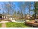 Picture-perfect backyard with inground pool, deck, patio, grassy lawn, and mature trees at 420 Woodlark Ct, Indian Trail, NC 28079