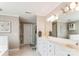 Neutral-toned bathroom features double sinks, white cabinets and tile flooring at 420 Woodlark Ct, Indian Trail, NC 28079