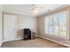 Small bedroom featuring carpet floors, white door, window with blinds, and beverage cooler at 420 Woodlark Ct, Indian Trail, NC 28079