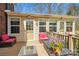 Cozy deck area with wicker chairs, table, flowers, and a serene view of the backyard at 420 Woodlark Ct, Indian Trail, NC 28079