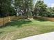 Spacious backyard features a new wooden fence, lawn and mature trees at 445 Short Hills Dr, Charlotte, NC 28217