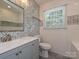 Beautiful bathroom featuring modern vanity, stylish tile work, and a window at 445 Short Hills Dr, Charlotte, NC 28217