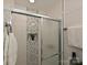 Modern bathroom shower featuring stylish tile surround and sliding glass door at 445 Short Hills Dr, Charlotte, NC 28217
