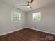 Bright bedroom with hardwood floors, ceiling fan, and two windows at 445 Short Hills Dr, Charlotte, NC 28217