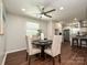 Bright dining area featuring a round table, stylish chairs, and a view into the modern kitchen at 445 Short Hills Dr, Charlotte, NC 28217